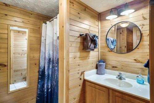 a bathroom with a sink and a mirror at Your Getaway Oasis in Sevierville