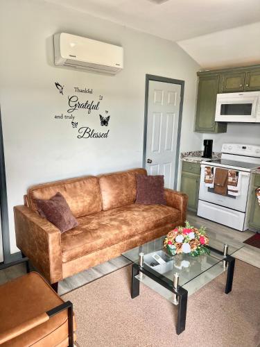 a living room with a brown couch and a table at Charming two bedroom duplex apartment in Autaugaville