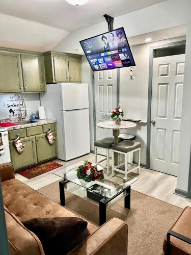 a living room with a couch and a table with a tv at Charming two bedroom duplex apartment in Autaugaville