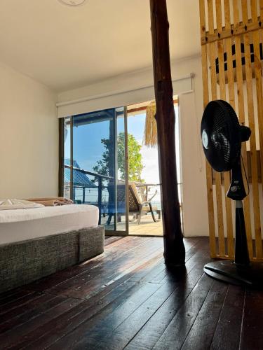 a bedroom with a bed and a large sliding glass door at SUNSET BEACH in Playa Blanca