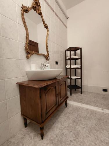 a bathroom with a sink and a mirror on the wall at Agriturismo Casa Alla Madonna in San Gimignano