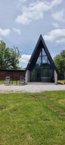 a building with two benches in a park at Oaza mira, Brutusi near Bjelašnica in Trnovo
