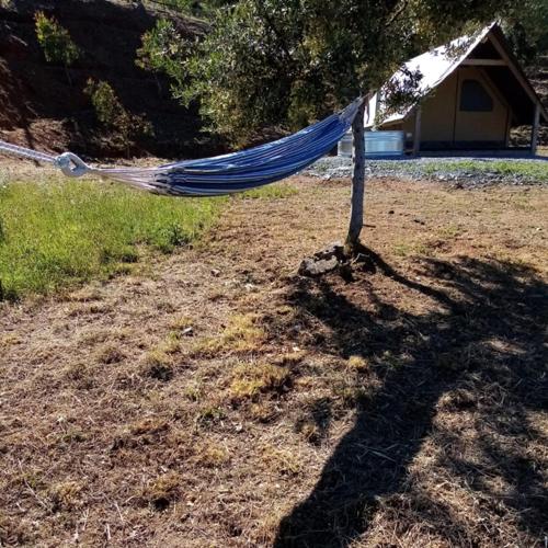 a blue hammock in the middle of a yard at Glamping - La Giara in San Demetrio Corone