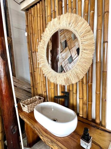 a bathroom with a white sink and a mirror at SUNSET BEACH in Playa Blanca
