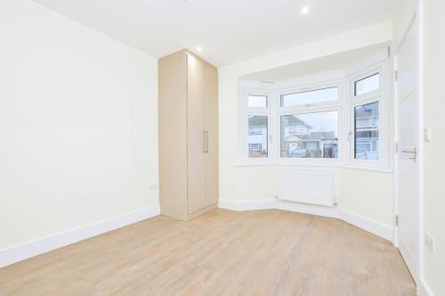 an empty room with white walls and a window at Luxury, comfort and Elegant Home in Hillingdon