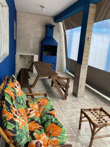 a room with a couch and a table and a fireplace at Júlia house in Ilha Comprida