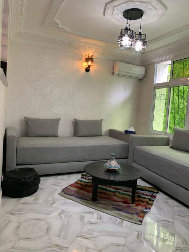 a living room with a couch and a coffee table at chez saad in Fès