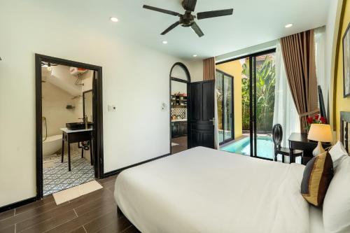 a bedroom with a bed and a bathroom with a tub at Hoi An 2BR private Pool Villa - Walk to Old Town in Hoi An