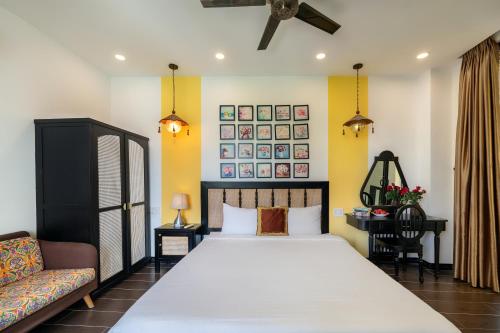 a bedroom with a large bed and a couch at Hoi An 2BR private Pool Villa - Walk to Old Town in Hoi An