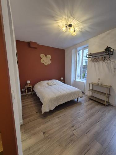 a bedroom with a bed and a ceiling fan at Charmant studio avec cour privée in Rochefort