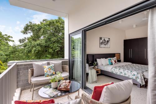 a bedroom with a bed and a balcony at Villa Reverie By AT Villas in Vagator