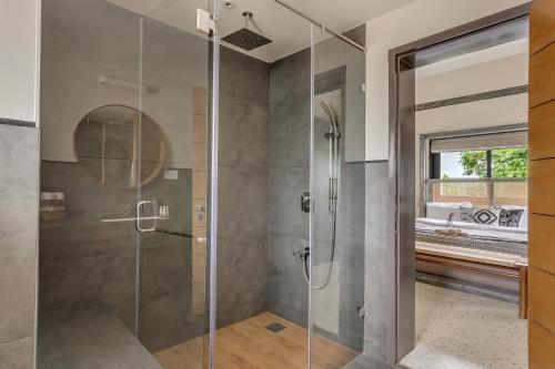 a shower with a glass door in a bathroom at Villa Reverie By AT Villas in Vagator