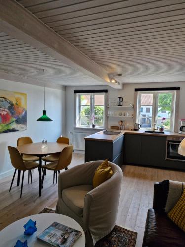 a living room and kitchen with a couch and a table at Walnuss in Nylarskirke