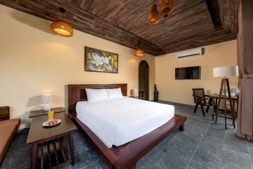 a bedroom with a bed and a dining room at Scenic Mountain Ecolodge Ninh Binh in Ninh Binh