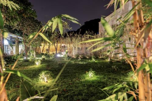 a garden at night with lights in the grass at Scenic Mountain Ecolodge Ninh Binh in Ninh Binh