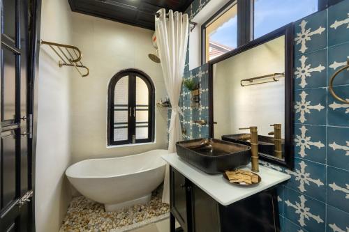 a bathroom with a tub and a sink and a bath tub at Hoi An 2BR private Pool Villa - Walk to Old Town in Hoi An