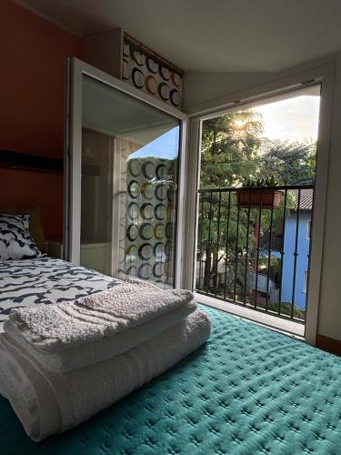 a bedroom with a bed and a large window at Appartamento Nuvola Bianca 2 in Cesenatico