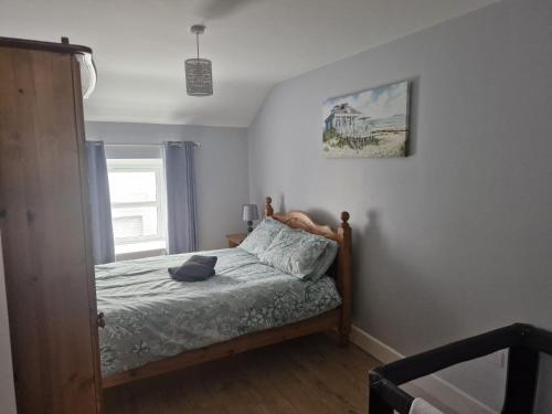 a bedroom with a bed and a picture on the wall at The Little Red Door in Warrenpoint
