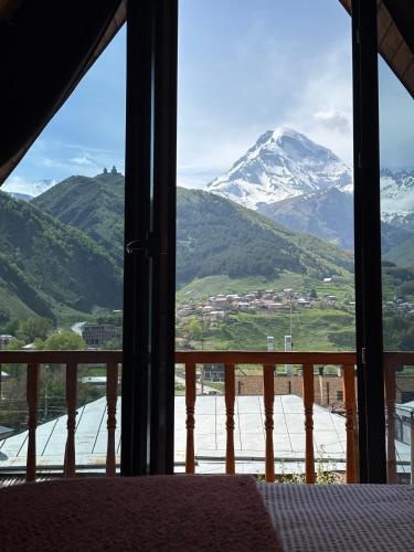 a view of a snow covered mountain from a room at Hideaway Kazbegi in Kazbegi