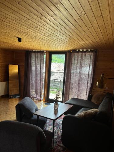a living room with a couch and a table at Hideaway Kazbegi in Kazbegi