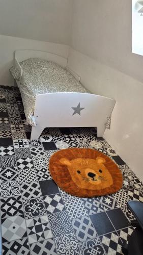 a laptop computer sitting on a floor next to a table at La petite normande in Appeville-Annebault