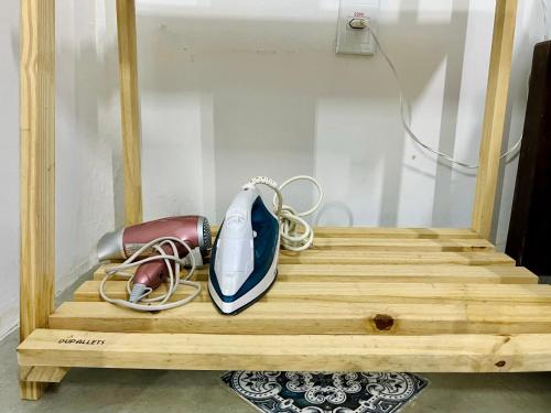 a pair of shoes sitting on a wooden shelf at CASINHA FLOR, vila florescer, centro histórico! in Piranhas