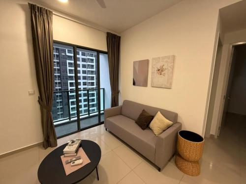 a living room with a couch and a large window at Shelisa's Modern 3BR House at Suria Garden Puchong in Puchong