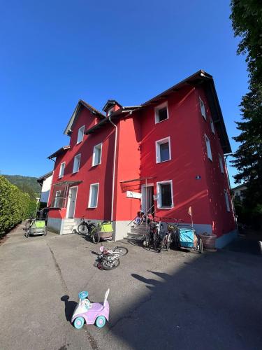 a red building with a toy car parked next to it at See oder Berg, Stadt oder Natur in Lochau