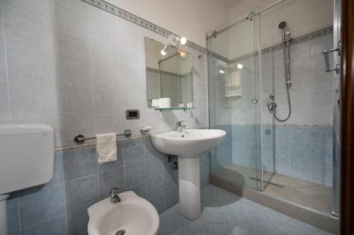 a bathroom with a sink and a shower and a toilet at Sofia Rooms in Castellammare del Golfo