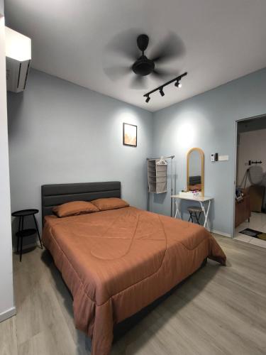 a bedroom with a bed and a ceiling fan at Horizon Staycation w WiFi in Sepang