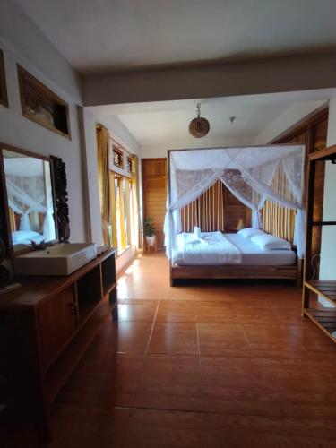 a large bedroom with a bed and a mirror at 361 Alam in Rarang