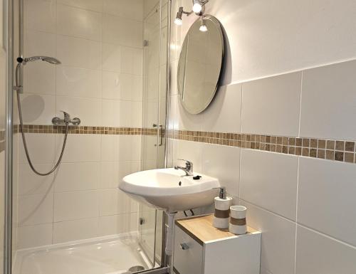 a white bathroom with a sink and a mirror at La Bohème Lodges and Glamping in Vrhaveč