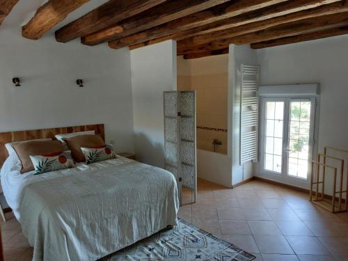 a bedroom with a large bed and a bathroom at Maison campagne proche Disney au calme in Saint-Cyr-sur-Morin