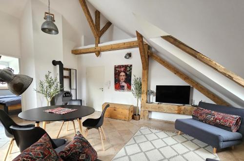 a living room with a table and chairs and a tv at La Bohème Lodges and Glamping in Vrhaveč