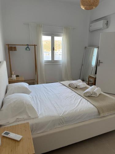 a bedroom with a large white bed with towels on it at Anemelia by the Sea - Lipsi in Lipsoi