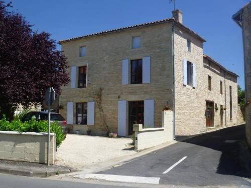 a large brick building on the side of a street at Le Grenier 1 Rue Verte Tusson 16140 France in Tusson