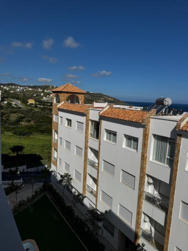 an aerial view of two buildings with the ocean in the background at Séjour Bab Diki in Melîyech