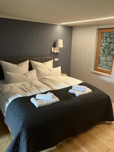 a large bed in a room with two towels on it at Hiestands Gästehaus - Weingut & Hofbrennerei in Guntersblum