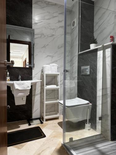 a bathroom with a shower and a sink and a toilet at Séjour Bab Diki in Melîyech