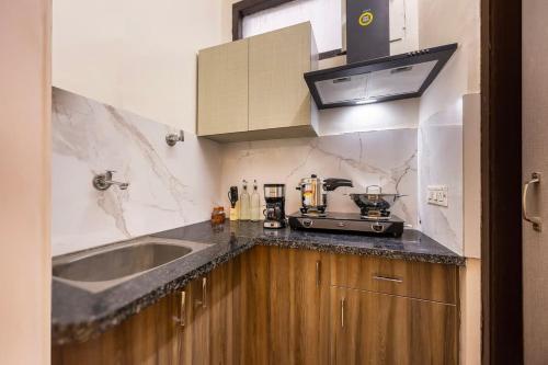 a kitchen with a sink and a counter top at Eco-friendly luxury awaits you with Garden in Gurgaon