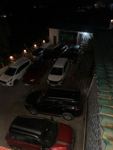 a group of cars parked in a parking lot at night at Silver Petal Hospitality in Panchgani