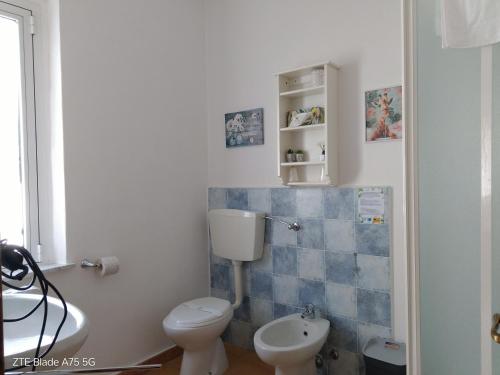 a bathroom with a toilet and a sink at La Castagna Matta in Albareto
