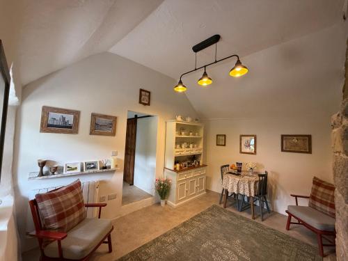 a living room with a table and chairs at Murphys Thatched Cottage in Mitchelstown