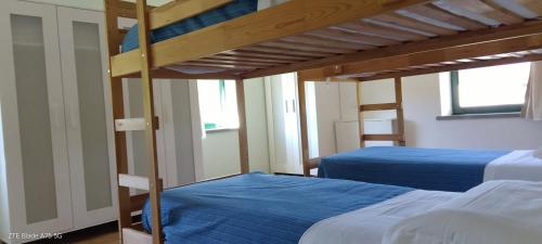 two beds in a room with two bunk beds at La Castagna Matta in Albareto