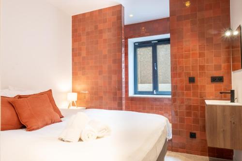 a bedroom with a bed and a bathroom with a shower at Jardin du Béguinage - Peaceful Luxury Home in Brussels in Brussels