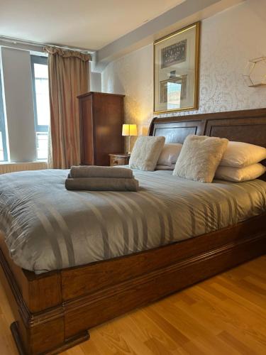 a bedroom with a large bed with pillows on it at Large 2 bedroom 2 bathroom x6 person city center apartment with free underground parking in Belfast