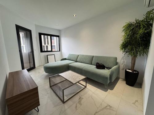 a living room with a green couch and a coffee table at little caifornia in Sidi Daoud