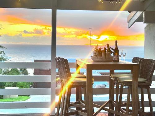 a dining room table with a view of the ocean at Hallett Cove Sunset Getaway in Hallett Cove