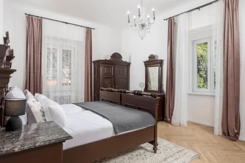 a bedroom with a large bed and a chandelier at Apartment Nina in Bakar