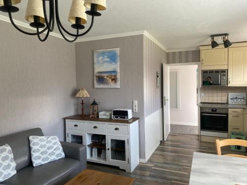 a living room with a couch and a kitchen at Haus Carstensen-Bungalow 2 in Wyk auf Föhr